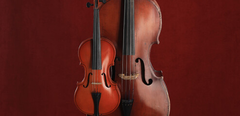 Fototapeta na wymiar cello and violin on a red background