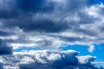 Dramatic blue sky with white clouds background.