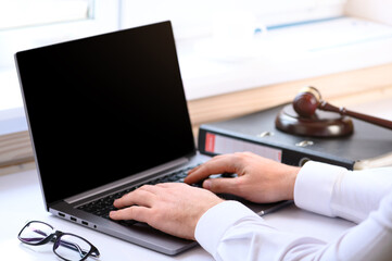 . Jurisprudence courses. On the table there is a computer and a folder with business papers. Online...