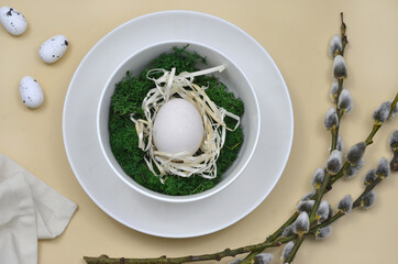 easter table setting, eggs on plate, moss and catkins