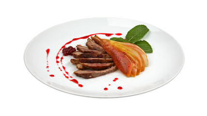 Sliced roasted duck fillet with pear and berry sauce on white round plate