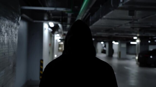 silhouettes of man walking in the car parking
