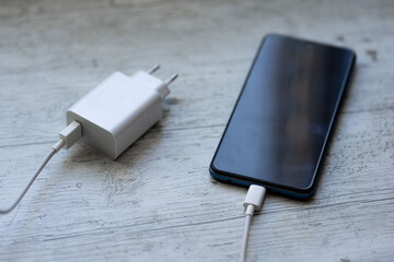 smartphone charger with power bank on white wood