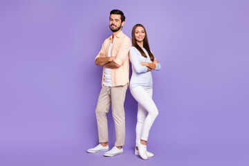 Full size photo of two satisfied friendly persons folded hands beaming smile isolated on violet...