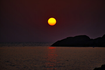 Sundown above sea horizon at sunset. Sunrise sky warm colors over ocean. Big sunset into the sea in Thailand.