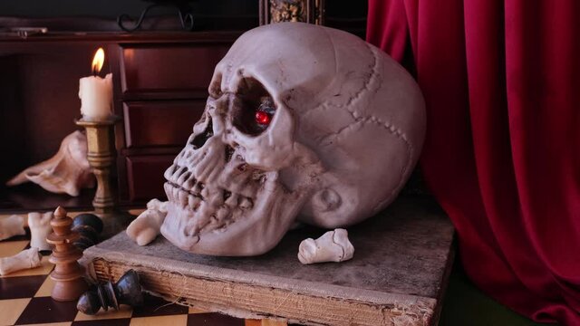 allegorical still life in the baroque genre Vanitas, a skull on a book, chess, candles are burning, concept of the transience of life, the futility of pleasures and inevitability of death