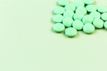 Green pills on the green background, medical banner