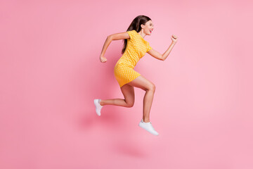 Fototapeta na wymiar Full size profile side photo of charming cheerful trendy young woman jump up run copyspace isolated on pink color background