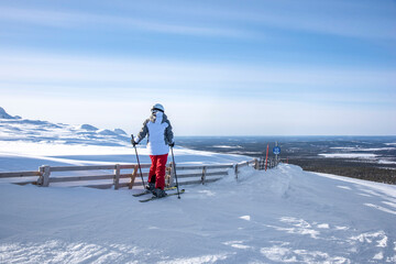 Woman downhill skiing in Lapland Finland