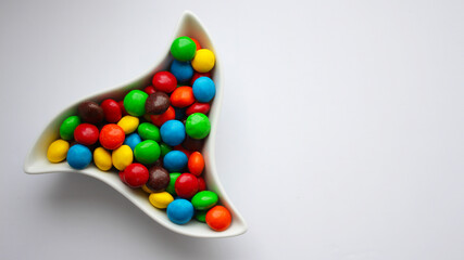 Close up of a bunch of colorful chocolates in a plate. mm