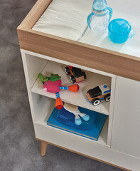 Baby room furniture corner of bed and drawer with toy style.