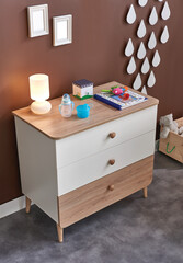 Baby room furniture design wooden concept cabinet. Brown wall background.