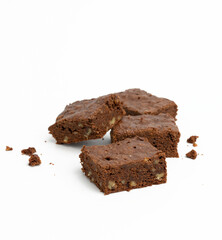 baked chocolate brownie pieces with walnut on white background, delicious dessert