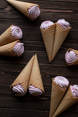 Waffle cones with marshmallows. View from above. Creative flat lay, copy space.