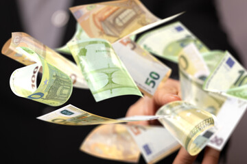 euro bills flying around  in hand