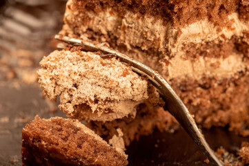 Chocolate cake and a metal fork. Close-up, selective focus.