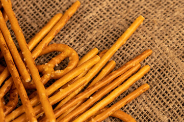 Salted breadsticks and salted pretzels scattered on the table.