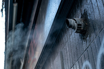 Newcastle upon Tyne UK - 8th Jan 2020: Grimy oily-looking vent emits smoke