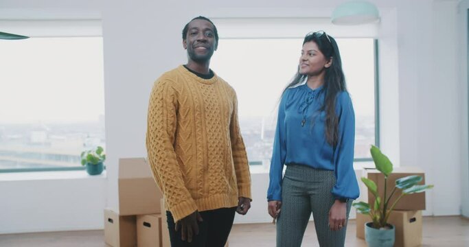 Cheerful multiethnic couple just moved in their new apartment 