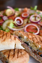 Cheese, bacon and mushrooms  panini with salad on a plate