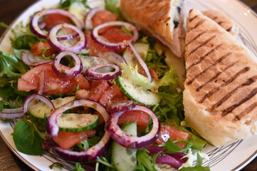 Cheese, bacon and mushrooms  panini with salad on a plate