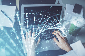 Double exposure of woman hands typing on computer and DNA hologram drawing. Medical education...