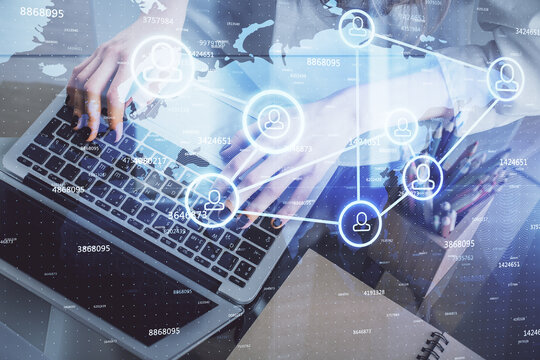 Double exposure of woman hands typing on computer and social network theme hologram drawing. People media concept.
