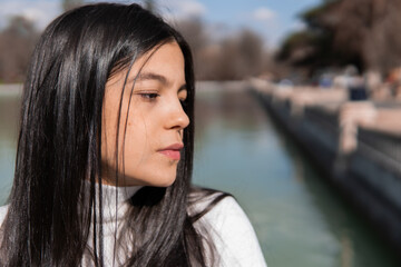 Portrait of young colombian girl with lake in the background