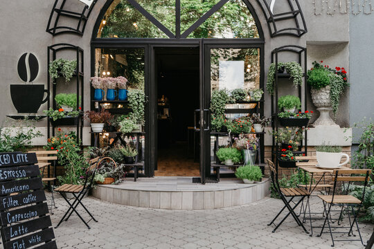 Open front door of modern flower studio, shop and cafe in rustic style during covid-19