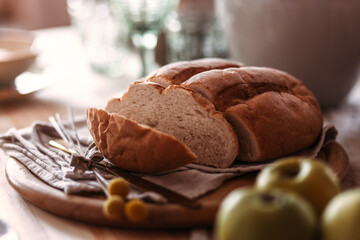Homemade rustic bread loaf with slices on wooden background
