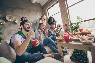 Full body photo of cheerful happy people men and women look watch tv watch game drink inside house home