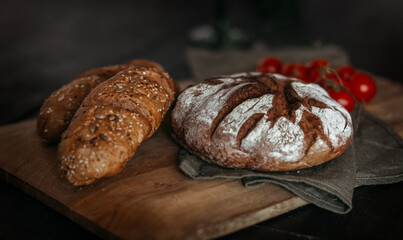 Fresh baked bread on dark wooden background.