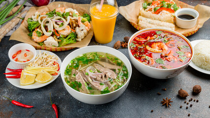 Assorted asian dinner, vietnamese food. Pho bo, pho tom, noodles, spring rolls, tom yam, rice,...