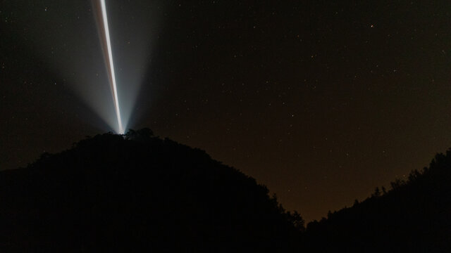 Lighthouse light that cuts through the starry sky - Powered by Adobe