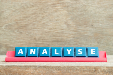 Tile alphabet letter with word analyse in red color rack on wood background