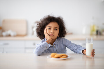 Portrait Of Sad Little Black Girl Holding Glass Of Milk