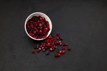 Frozen cranberry on dark background with copy space. Natural source of vitamin C, an ingredient for healthy smoothies or fruit drinks