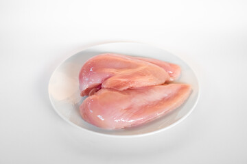 Raw chicken breast fillets isolated on white background.