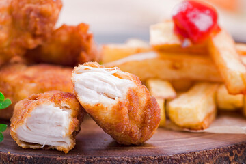 crispy chicken nuggets Crunchy homemade fries on a white napkin