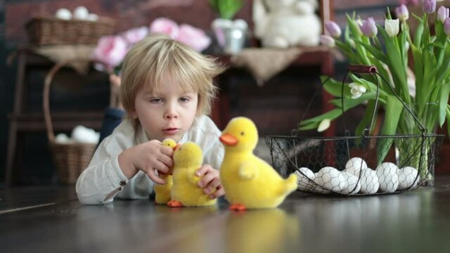 Cute toddler blond child, boy with easter decoration in studio