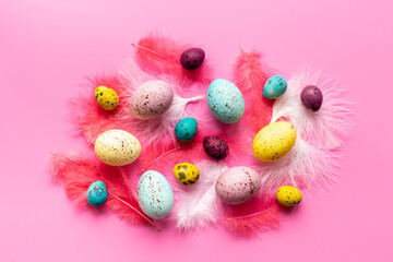 Happy Easter card with colorful eggs and feather. Overhead view