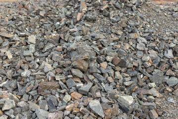 Crushed mountain stones on the ground texture background in the image