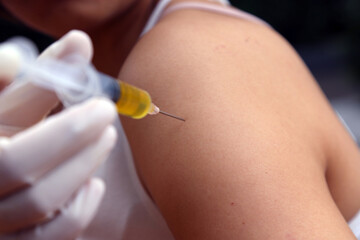 heal vaccine and medicine syringe to arm of human