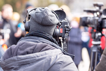 Filming an media event or news conference with a video camera. Public relations - PR concept.
