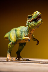 Dinosaurier auf Holzpallte mit braun gelben Hintergrund