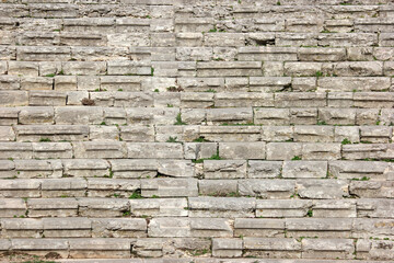 Close up of old weathered grey brick wall.