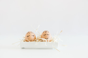 Brown hand drawn eggs with faces in the nest. Gift card for your design, place for text. Minimalist Easter.