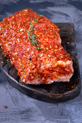 Pork neck meat in marinade made of mustard, oil, spices and herbs. Preparing meat for cooking