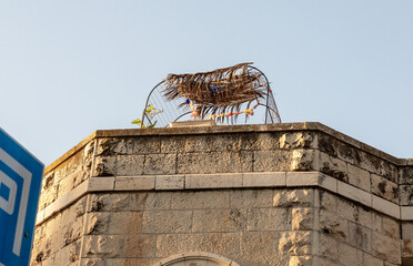 Evening  view of the decorative pergola covered with palm branches on the roof of a residential...