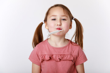 Girl with a toothbrush in her mouth